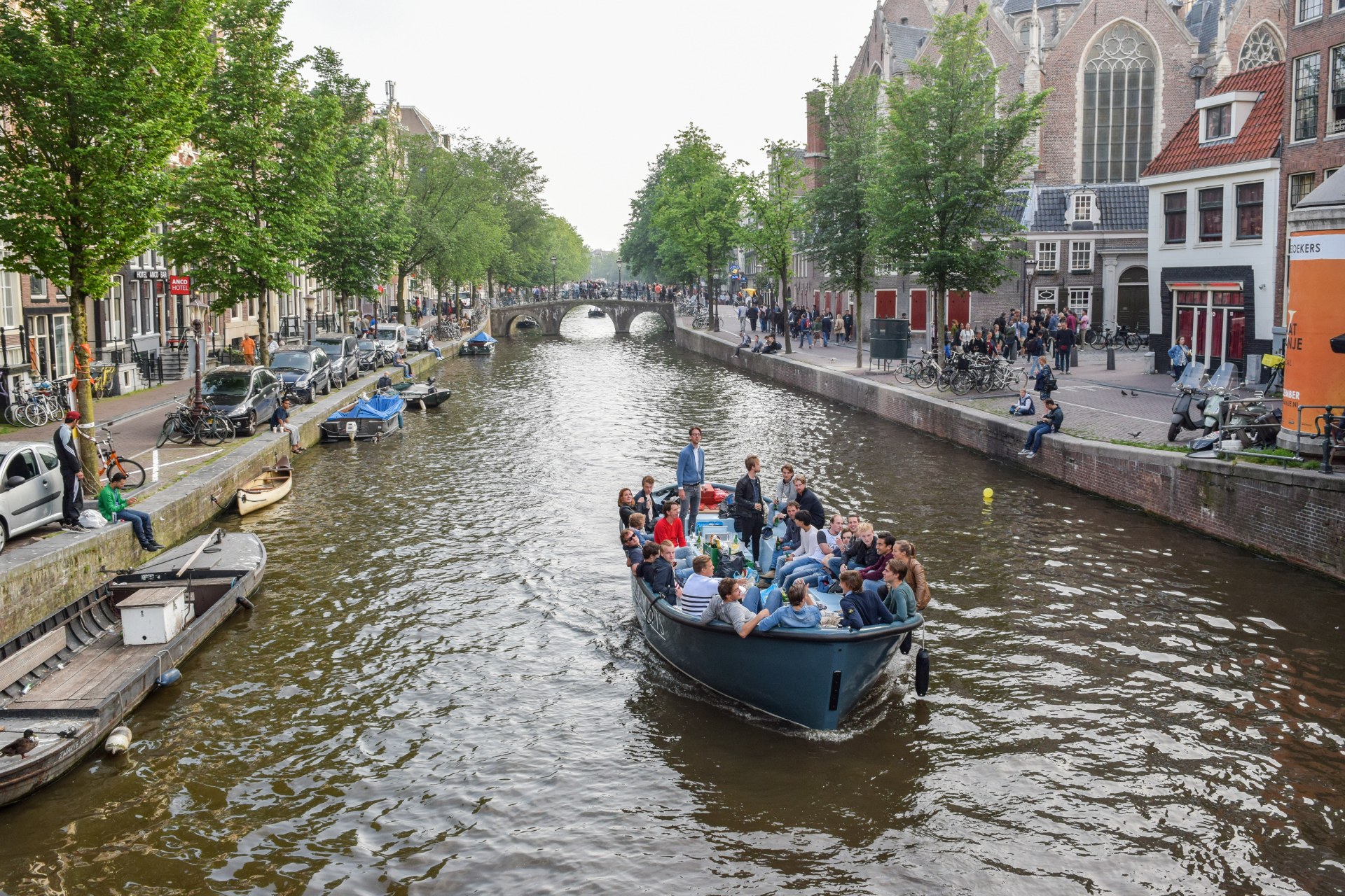Young people on a boat on an Amsterdam canal